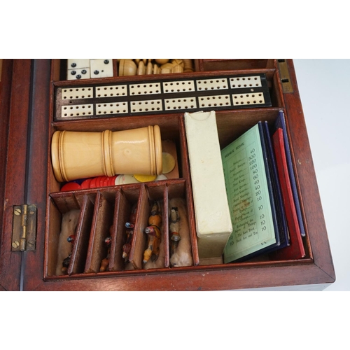 197 - An early 20th century wooden cased games compendium to include Solitaire, Cribbage, Chess....etc. Co... 