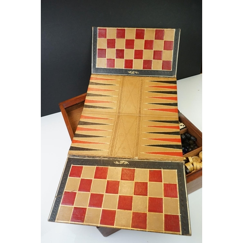 197 - An early 20th century wooden cased games compendium to include Solitaire, Cribbage, Chess....etc. Co... 