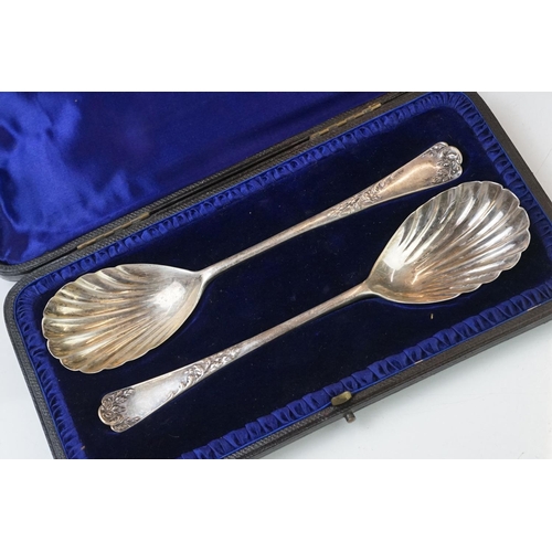 202 - A cased set of six hallmarked sterling silver tea spoons together with a cased pair of fully hallmar... 