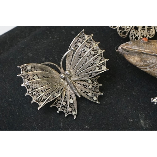 205 - A small collection of brooches to include filigree Butterflies together with two display stands.