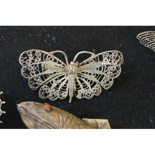 205 - A small collection of brooches to include filigree Butterflies together with two display stands.