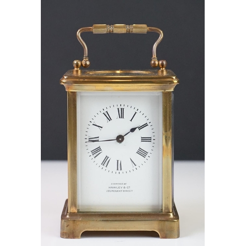 209 - A brass cased carriage clock with bevelled glass panels, the dial marked Hawley & Co of Regent St. L... 