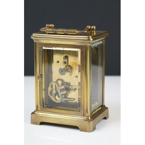 209 - A brass cased carriage clock with bevelled glass panels, the dial marked Hawley & Co of Regent St. L... 