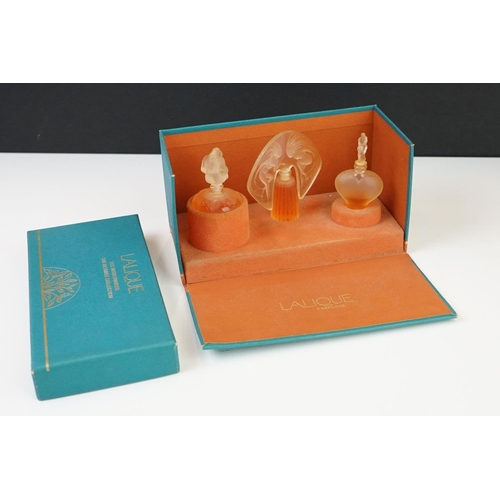 215 - Two boxed sets of Lalique collection miniature scent bottles.