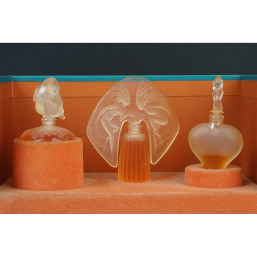 215 - Two boxed sets of Lalique collection miniature scent bottles.