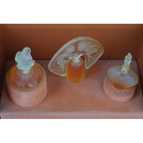 215 - Two boxed sets of Lalique collection miniature scent bottles.