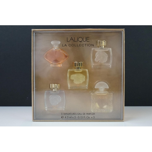 215 - Two boxed sets of Lalique collection miniature scent bottles.