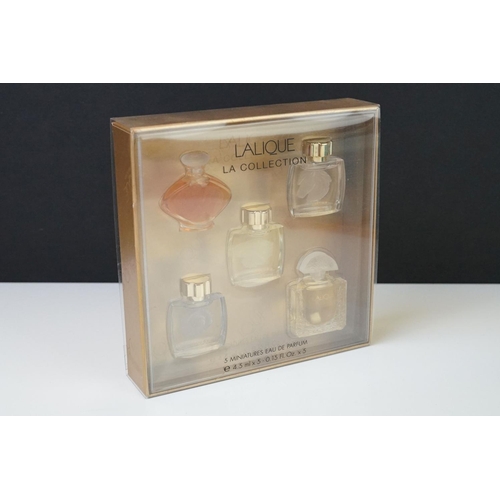 215 - Two boxed sets of Lalique collection miniature scent bottles.