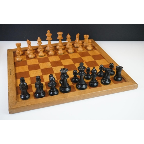 221 - Two vintage boxwood chess sets together with wooden chess board and two associated brushes.