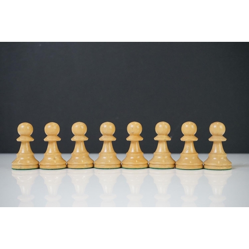 221 - Two vintage boxwood chess sets together with wooden chess board and two associated brushes.