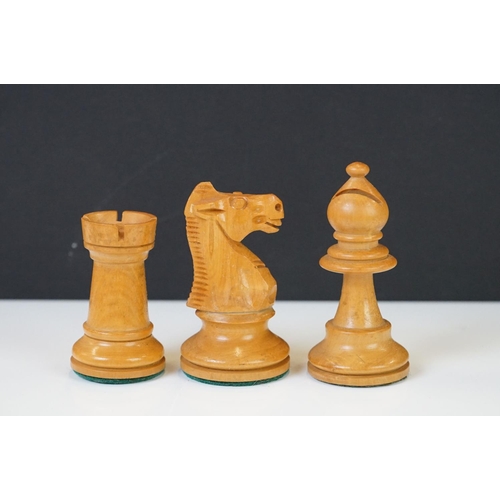 221 - Two vintage boxwood chess sets together with wooden chess board and two associated brushes.