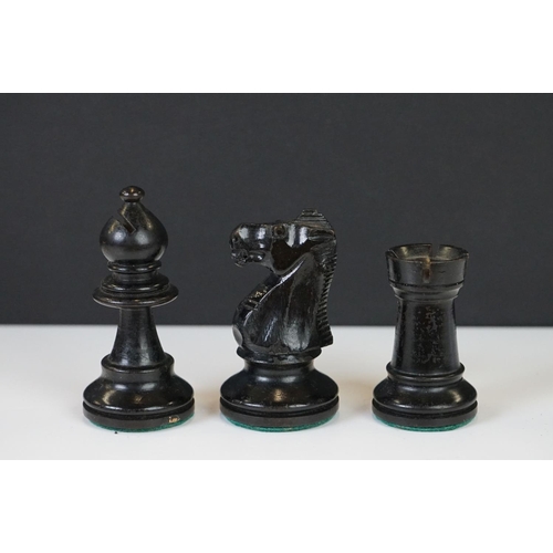 221 - Two vintage boxwood chess sets together with wooden chess board and two associated brushes.