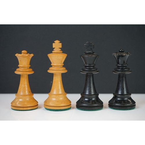 221 - Two vintage boxwood chess sets together with wooden chess board and two associated brushes.