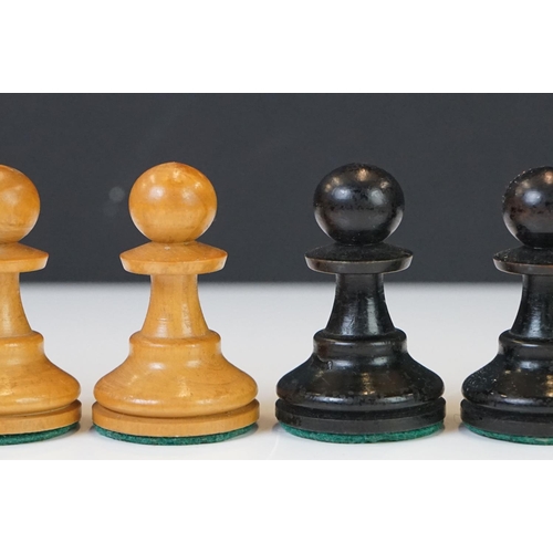 221 - Two vintage boxwood chess sets together with wooden chess board and two associated brushes.