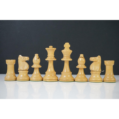 221 - Two vintage boxwood chess sets together with wooden chess board and two associated brushes.