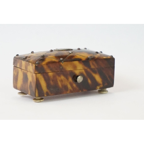 275 - An antique faux tortoiseshell trinket box with central cartouche to the hinged lid and turned bone f... 