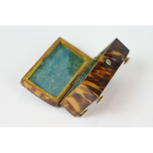 275 - An antique faux tortoiseshell trinket box with central cartouche to the hinged lid and turned bone f... 