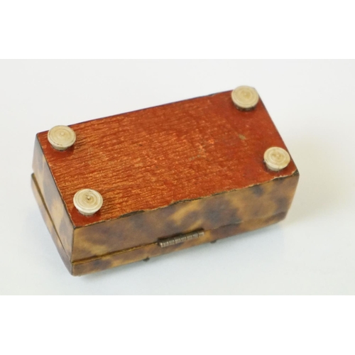 275 - An antique faux tortoiseshell trinket box with central cartouche to the hinged lid and turned bone f... 