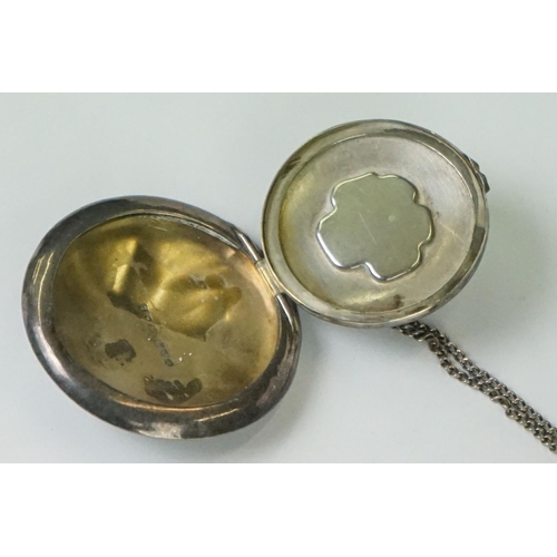 278A - A fully hallmarked sterling silver pill box on a white metal necklace, assay marked for Chester and ... 