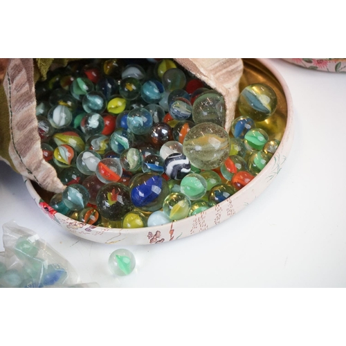 328 - A collection of vintage marbles contained within three boxes.