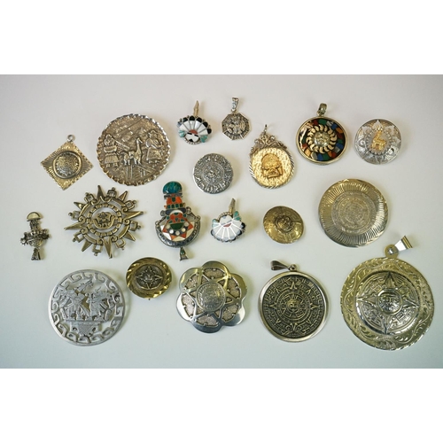 337 - A collection of 925 sterling silver Mexican / Peruvian pendants and brooches.