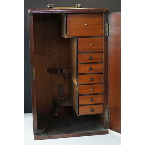 186 - A mahogany cased microscope by J.B. Dancer of Manchester with extra lenses, slides...etc.