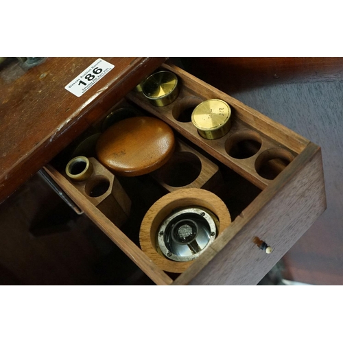 186 - A mahogany cased microscope by J.B. Dancer of Manchester with extra lenses, slides...etc.