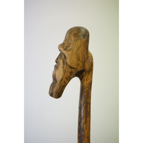 392 - A vintage hand carved walking stick with figural head handle.