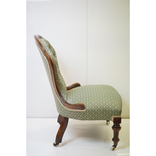 559 - Victorian Walnut Nursing Chair with waisted back, green button back upholstery, raised on turned fro... 