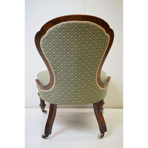 559 - Victorian Walnut Nursing Chair with waisted back, green button back upholstery, raised on turned fro... 