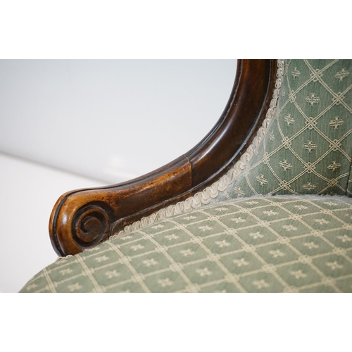 559 - Victorian Walnut Nursing Chair with waisted back, green button back upholstery, raised on turned fro... 