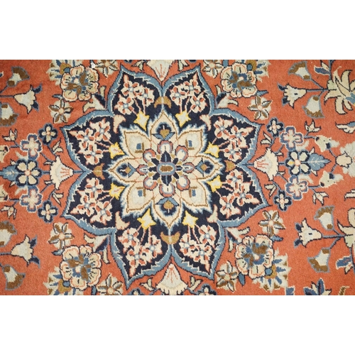 557 - Pink and Cream Ground Rug with floral pattern within a border, 256cm x 200cm