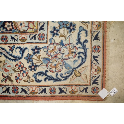 557 - Pink and Cream Ground Rug with floral pattern within a border, 256cm x 200cm