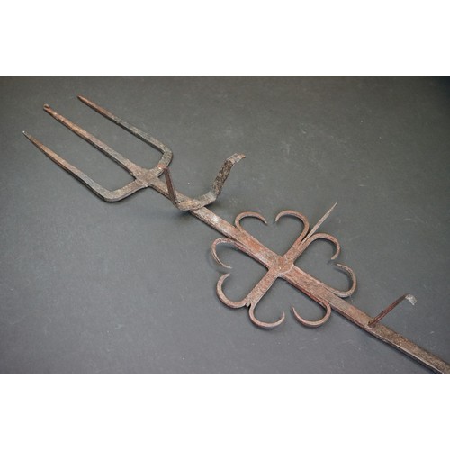 412 - A small group of brass trivets and fire side tools including a 17th century downhearth toasting fork... 