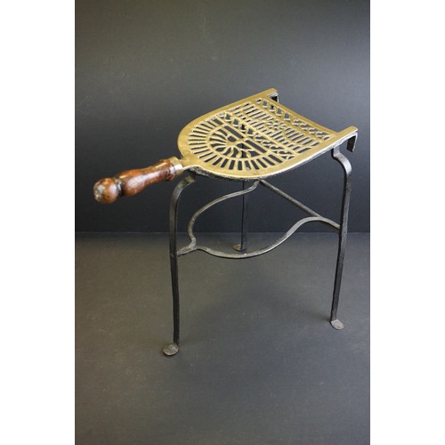 412 - A small group of brass trivets and fire side tools including a 17th century downhearth toasting fork... 