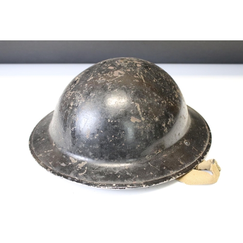 169 - A Collection Of Three Military Helmets To Include A British World War Two Brodie Example.