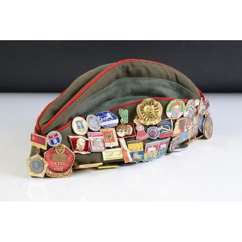 373 - A Russian Military Side / Forage Cap With A Large Quantity Of Attached Pin Badges.