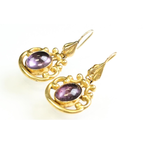 31 - Pair of 19th century amethyst yellow metal drop earrings, the oval cabochon cut amethyst measuring a... 