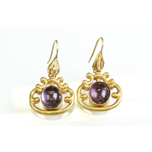 31 - Pair of 19th century amethyst yellow metal drop earrings, the oval cabochon cut amethyst measuring a... 