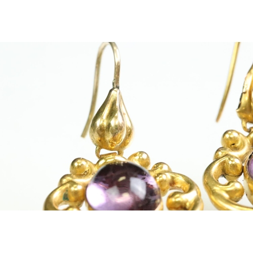 31 - Pair of 19th century amethyst yellow metal drop earrings, the oval cabochon cut amethyst measuring a... 