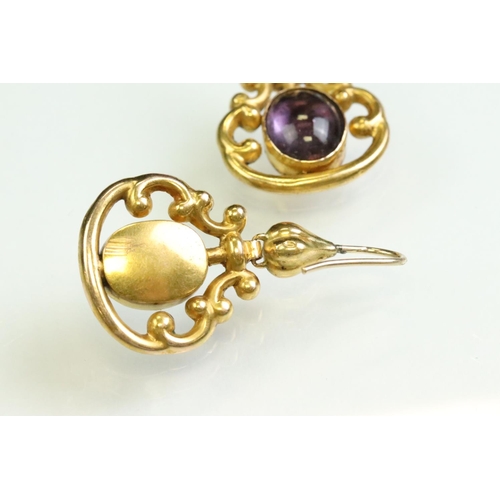 31 - Pair of 19th century amethyst yellow metal drop earrings, the oval cabochon cut amethyst measuring a... 