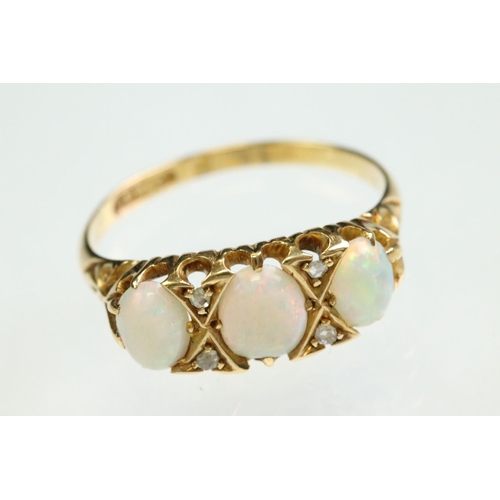 38 - Opal and diamond yellow gold ring, three graduated oval cabochon cut precious white opals, displayin... 