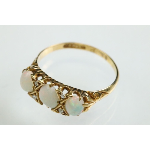 38 - Opal and diamond yellow gold ring, three graduated oval cabochon cut precious white opals, displayin... 