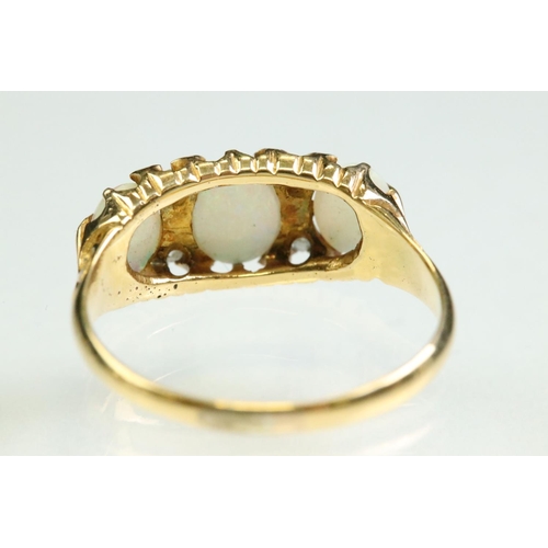 38 - Opal and diamond yellow gold ring, three graduated oval cabochon cut precious white opals, displayin... 