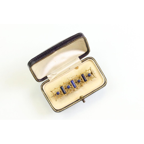 49 - Victorian lapis lazuli yellow metal brooch, three rectangular cabochon cut and four round cabochon c... 