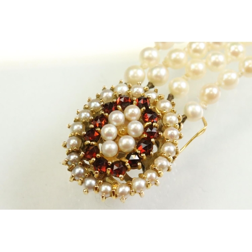 54 - Garnet and pearl 9ct yellow gold bracelet, the oval clasp set with two rows of cream cultured pearls... 