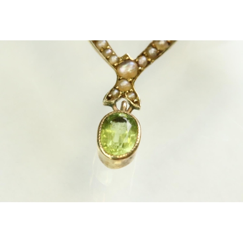 56 - Early 20th century peridot, ruby and seed pearl unmarked yellow gold pendant, the openwork trefoil f... 