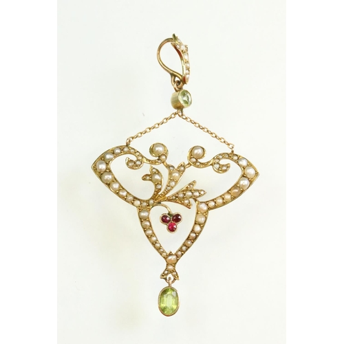 56 - Early 20th century peridot, ruby and seed pearl unmarked yellow gold pendant, the openwork trefoil f... 