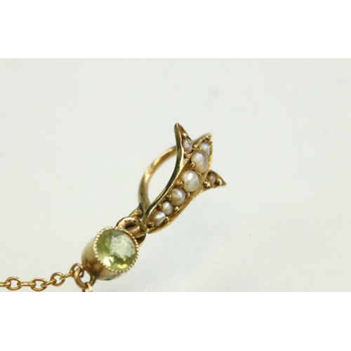 56 - Early 20th century peridot, ruby and seed pearl unmarked yellow gold pendant, the openwork trefoil f... 