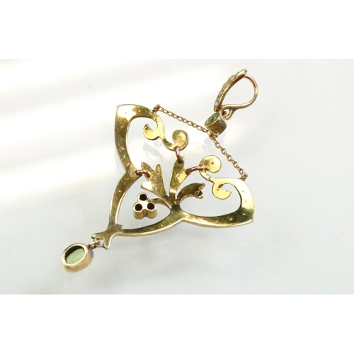 56 - Early 20th century peridot, ruby and seed pearl unmarked yellow gold pendant, the openwork trefoil f... 